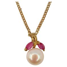 Introducing our Vintage Marquise Cut Rubies & Pearl Necklace Pendant in 14K Yellow Gold, a timeless piece of jewelry that blends vintage charm with contemporary elegance. At the heart of this pendant lies a lustrous Freshwater Cultured Round Pearl, measuring a delicate 6.50mm in diameter. This pearl, known for its purity and classic beauty, symbolizes wisdom acquired through experience, making it a truly special addition to this necklace. On top of the pearl are two Marquise Cut Rubies, totaling approximately 0.14 carats. Rubies, with their deep red hue, have long been associated with passion, love, and courage. These exquisite rubies add a touch of color and vibrancy to the pendant, creating a harmonious contrast with the pearl's soft luminosity. Meticulously crafted in 14K yellow gold, t Vintage Yellow Gold Pearl Pendant Necklace, Vintage Yellow Gold Gemstone Necklace, Vintage Birthstone Necklace For Formal Occasions, Vintage Birthstone Necklace For Weddings, Vintage Yellow Gold Birthstone Necklace, Rubies Necklace, Pearl Necklace Pendant, Ruby Pendant, Jewelry Lookbook