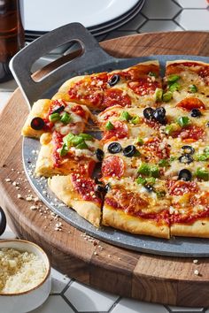 a pizza sitting on top of a pan covered in toppings