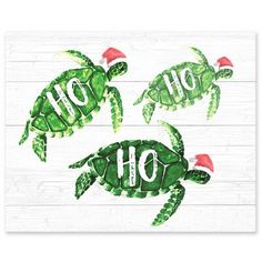 three green turtles with santa hats on their heads and the words ho hoo written in white