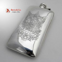 a silver flask with an image of a dog on it