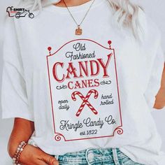 a woman wearing a white t - shirt with candy canes printed on the front