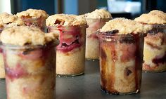 several desserts are arranged in small glass containers