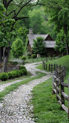 a cobblestone path leads to a log cabin in the woods near a wooded area