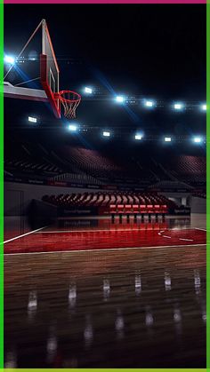 an empty basketball court with the lights on and a basket in the air above it