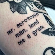 a person with a tattoo on their arm that says, serotronin mr man, lend me a gran