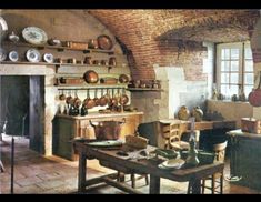 an old fashioned kitchen with lots of pots and pans