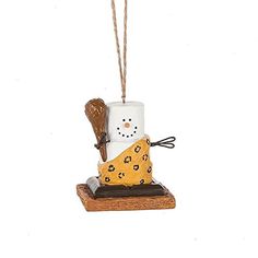 a snowman ornament hanging from a rope on a white background with a brown heart