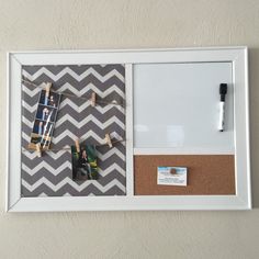 a cork board with clothes pins attached to it and pictures hanging on the pegs