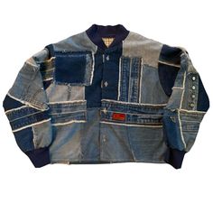 an old jean jacket with patches and buttons on the chest, sitting against a white background