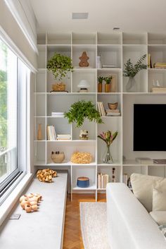 a living room filled with furniture and a flat screen tv