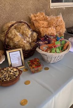 a table topped with lots of different types of food and snacks on top of it