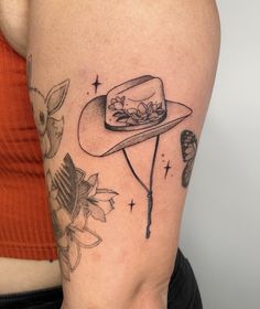 a woman's arm with a hat and flowers on it