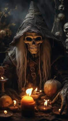 a skeleton with long hair sitting in front of candles