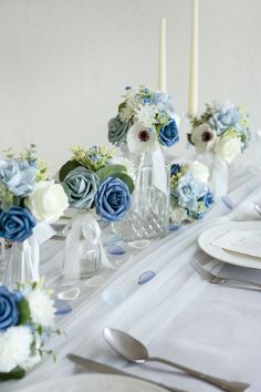 the table is set with blue and white flowers