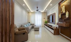 a living room filled with furniture and a flat screen tv on top of a wooden shelf