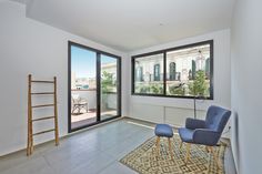 an empty living room with two blue chairs