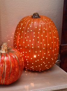 two decorative pumpkins sitting on top of a table