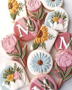 decorated cookies with flowers and letters on them