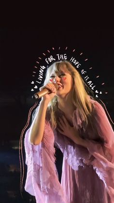 a woman in a pink dress holding a microphone and singing into the microphone with words above her head