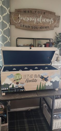 an upcycled trunk is sitting on a table in front of a wall sign