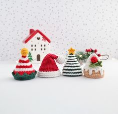 three crocheted christmas hats sitting next to each other