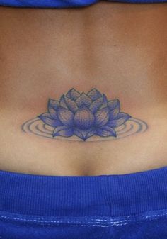 a woman's stomach with a lotus tattoo on it