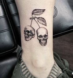 two skulls with leaves on the ankle