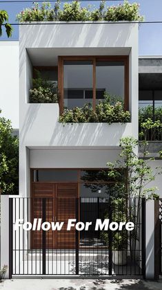 an apartment building with plants on the balconies