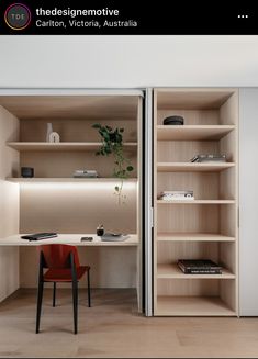 an open bookcase with shelves and a desk in the corner, next to a red chair