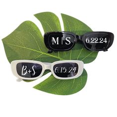 three glasses with the names of two people on them, and one has a green leaf