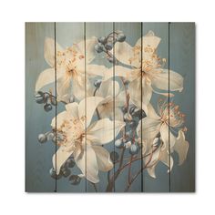 an art piece with white flowers and blue berries on the bottom, against a wooden background