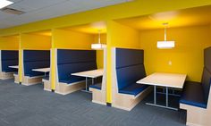 an empty room with blue and yellow booths