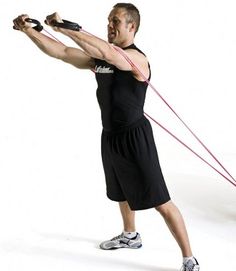 a man holding a rope while standing in front of a white background