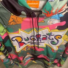 "Sometimes A Baby's Gotta Do What A Baby's Gotta Do." Rugrats Camo Hoodie Will Have You Reminiscing On All Your Favorite Babies. Cotton Camo Print Hoodie Rugrats Characters All Over Embroidered Rugrats Ligo 100% Authentic Size S Multicolor Casual Sweatshirt With Kangaroo Pocket, Multicolor Cartoon Print Hooded Hoodie, Playful Hooded Hoodie For Streetwear, Fun Cotton Hoodie, Fun Cotton Hooded Hoodie, Multicolor Streetwear Sweatshirt With Kangaroo Pocket, Playful Hoodie With Drawstring Hood For Streetwear, Playful Multicolor Hoodie With Drawstring, Green Hooded Top With Graphic Print