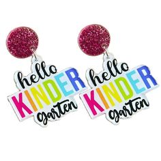 two earrings with the words hello, kind and kind written on them in different colors