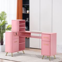 a pink desk with two drawers and a shelf next to it in front of a window