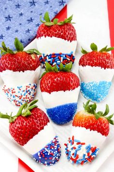 patriotic strawberries are on a plate with red, white and blue sprinkles