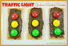 three pieces of bread with chocolate and candy candies on them in the shape of traffic lights