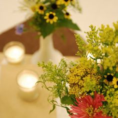 two vases filled with flowers on top of a table