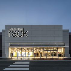 a store front with the word rack lit up at night