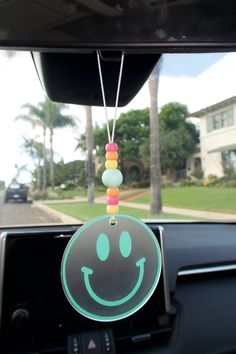 a car dashboard with a smiley face hanging from the dash board