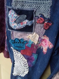 a blue jean jacket with patches and laces on it