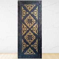 an intricately designed wooden door on a wood floor