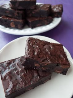 two white plates with brownies on them