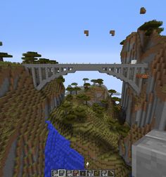 an image of a bridge in minecraft with trees and rocks on the side,