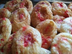 some very tasty looking pastries with red sprinkles