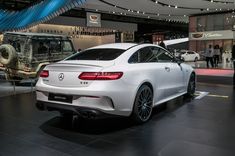 the rear end of a white mercedes s - class coupe on display at an auto show