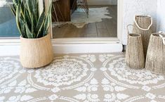 three vases sitting next to each other in front of a door with a window