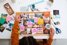 a woman is making a collage with pictures and magnets