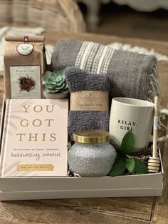 a gift box with towels, candles and other items